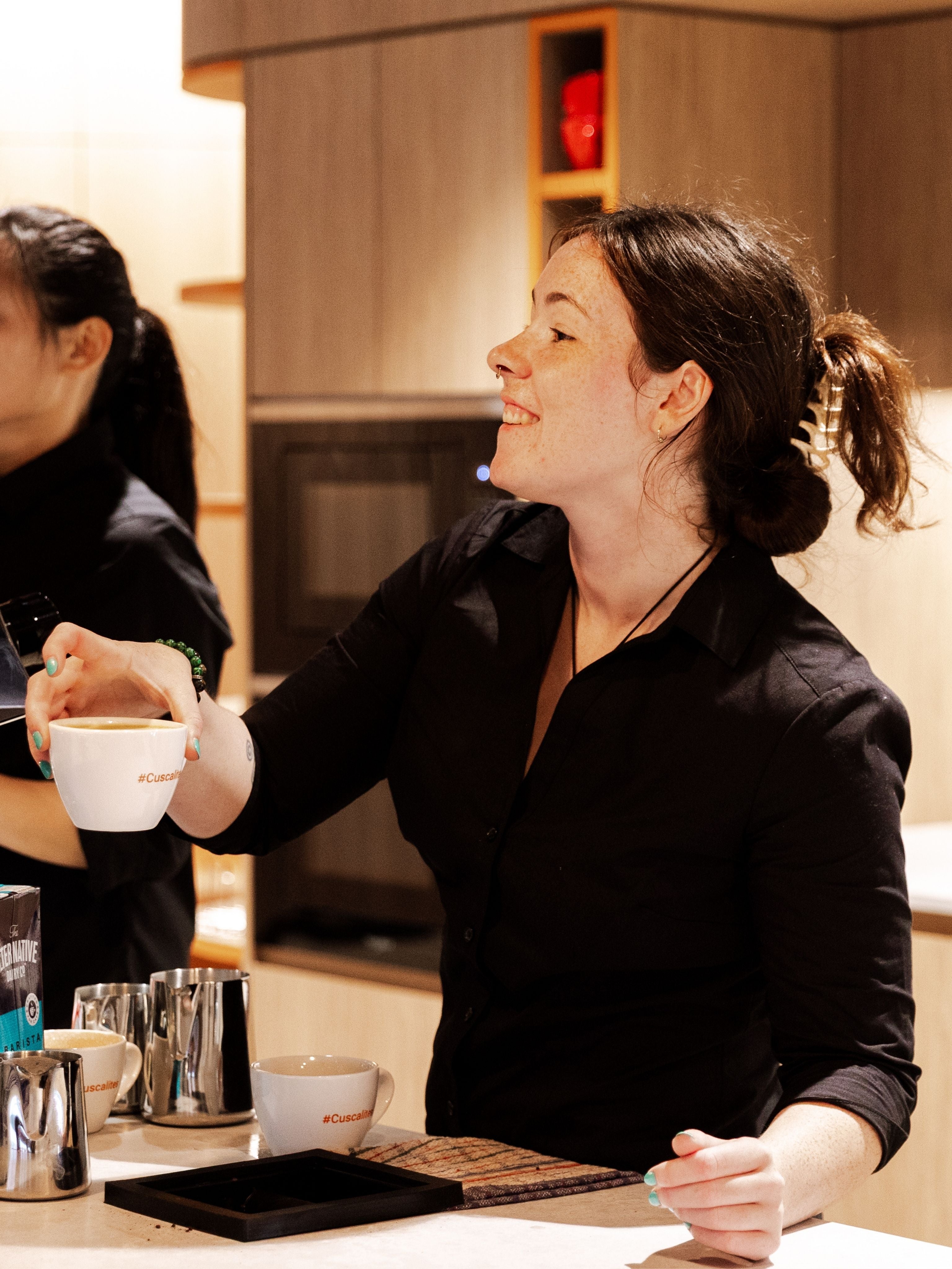 Workplace barista serving coffee to office staff members