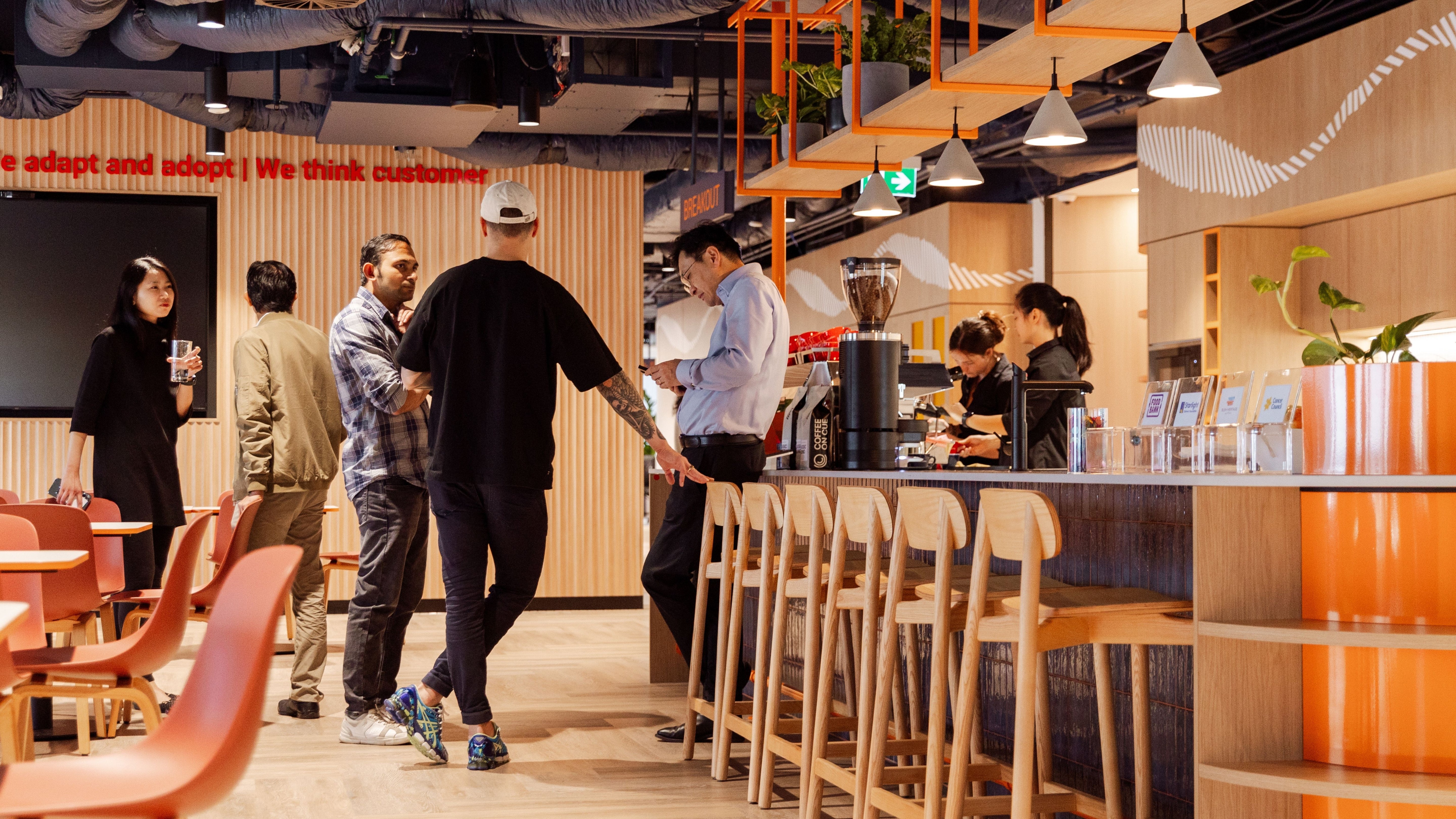 Staff getting coffee from workplace coffee bar