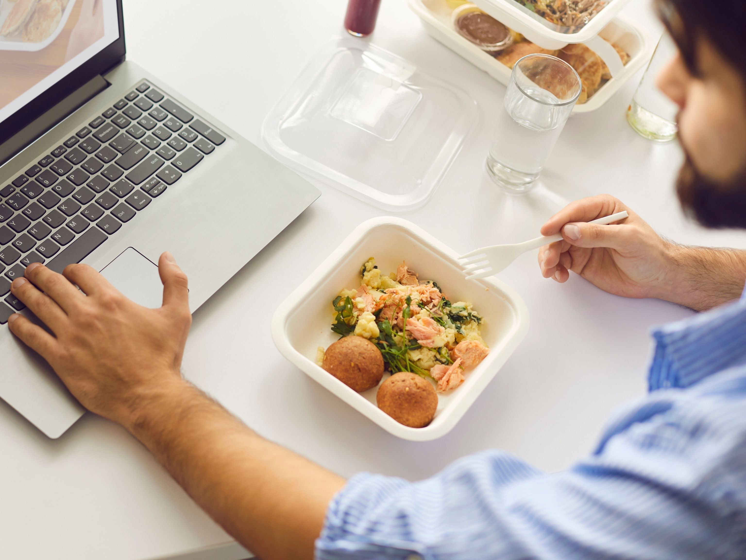 Employee eating healthy lunch at work