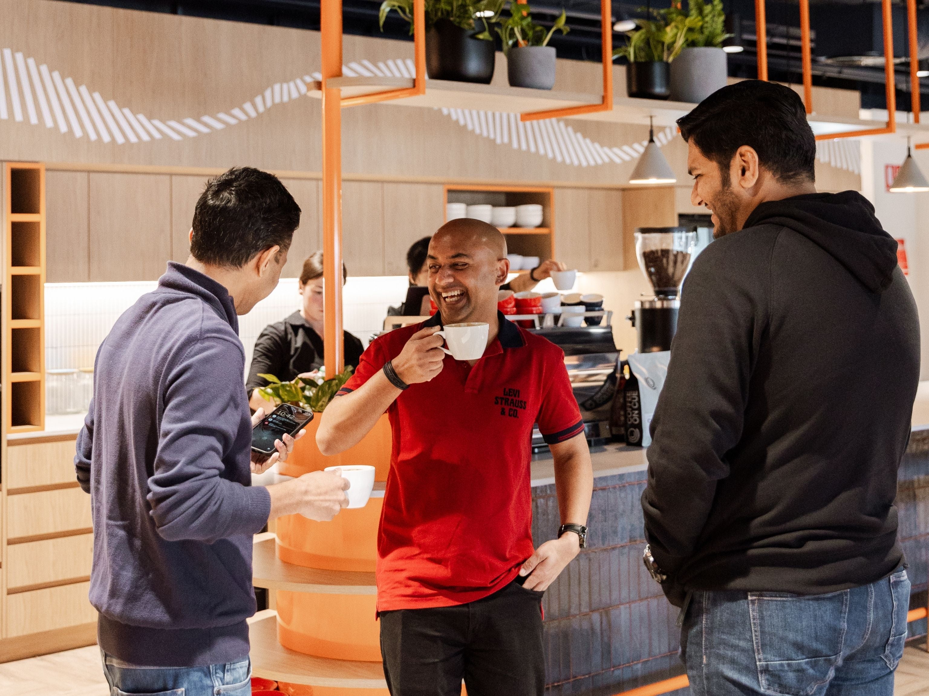 Happy employees drinking coffee at Cuscal