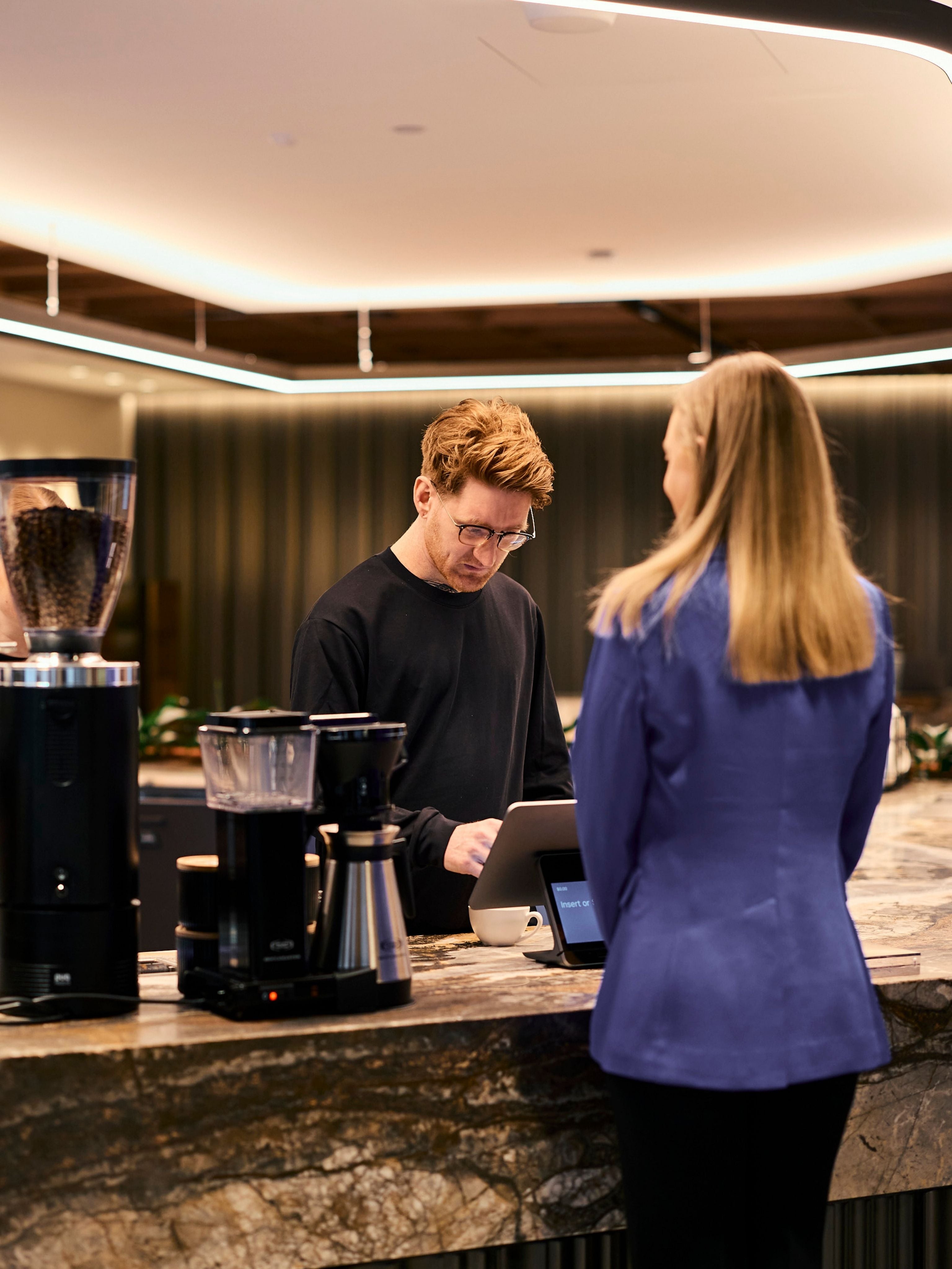JLL barista taking a customer order on the pos
