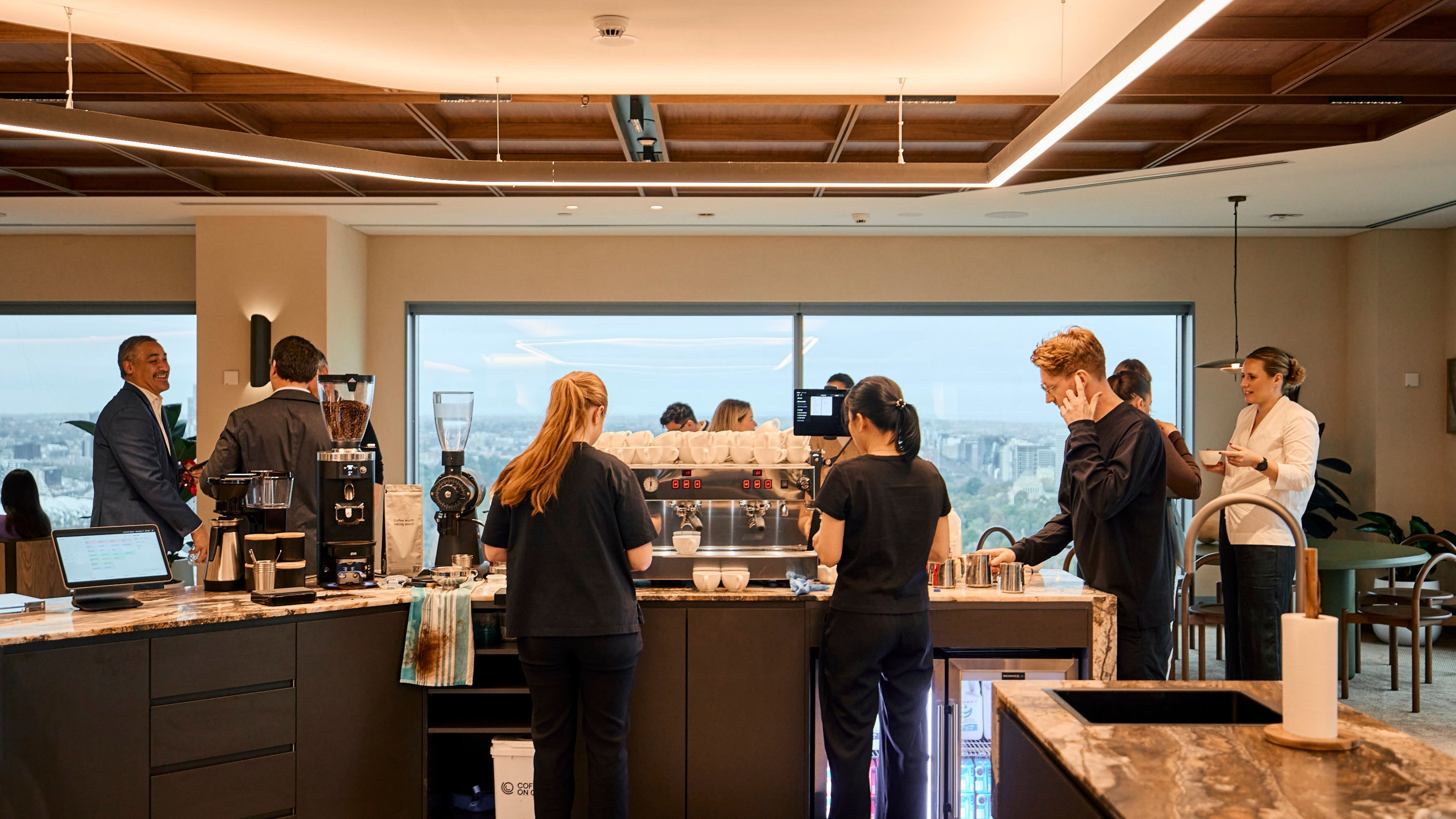 JLL workplace barista team behind the bar