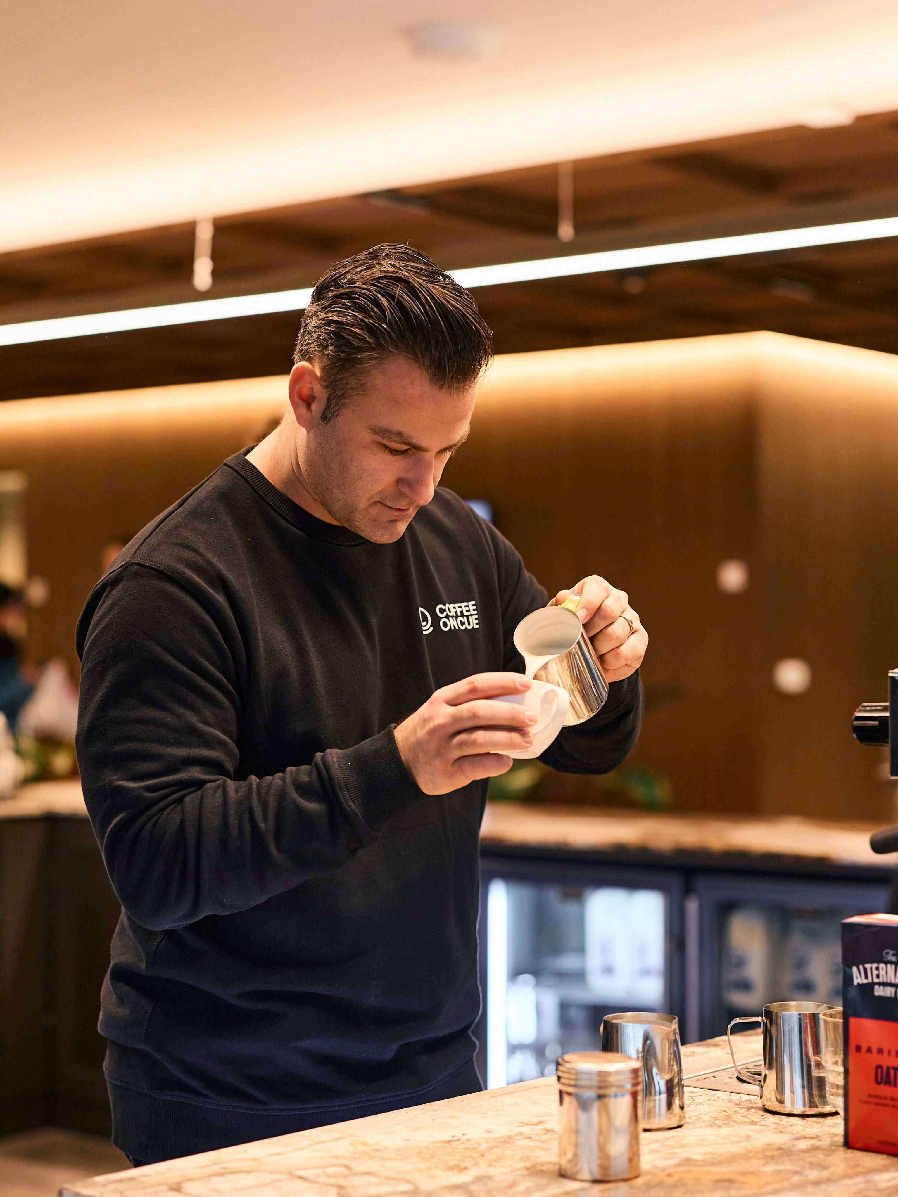 Ryan pouring a latte at the JLL workplace site in Melbourne